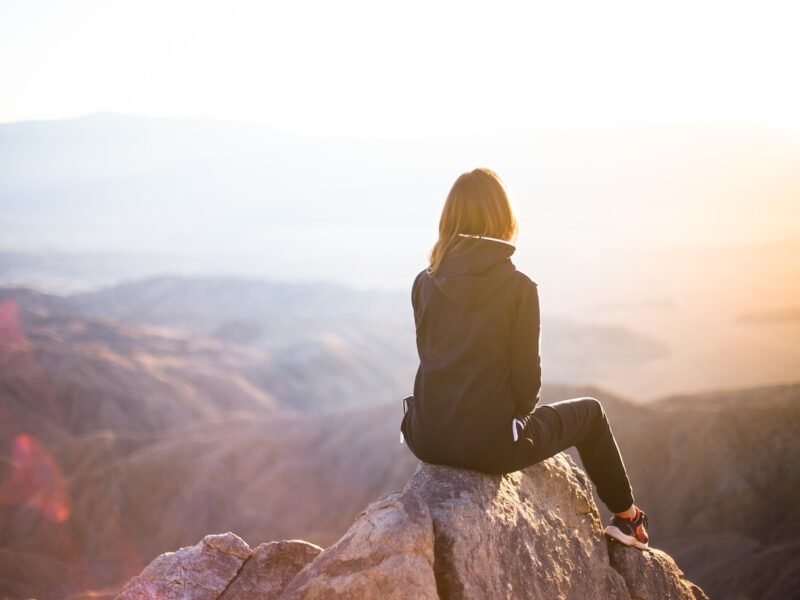 people, woman, travel, adventure, nature, trek, mountain, rock, sunset, cliff, black, hoodie, jacket, alone, thinking, freedom