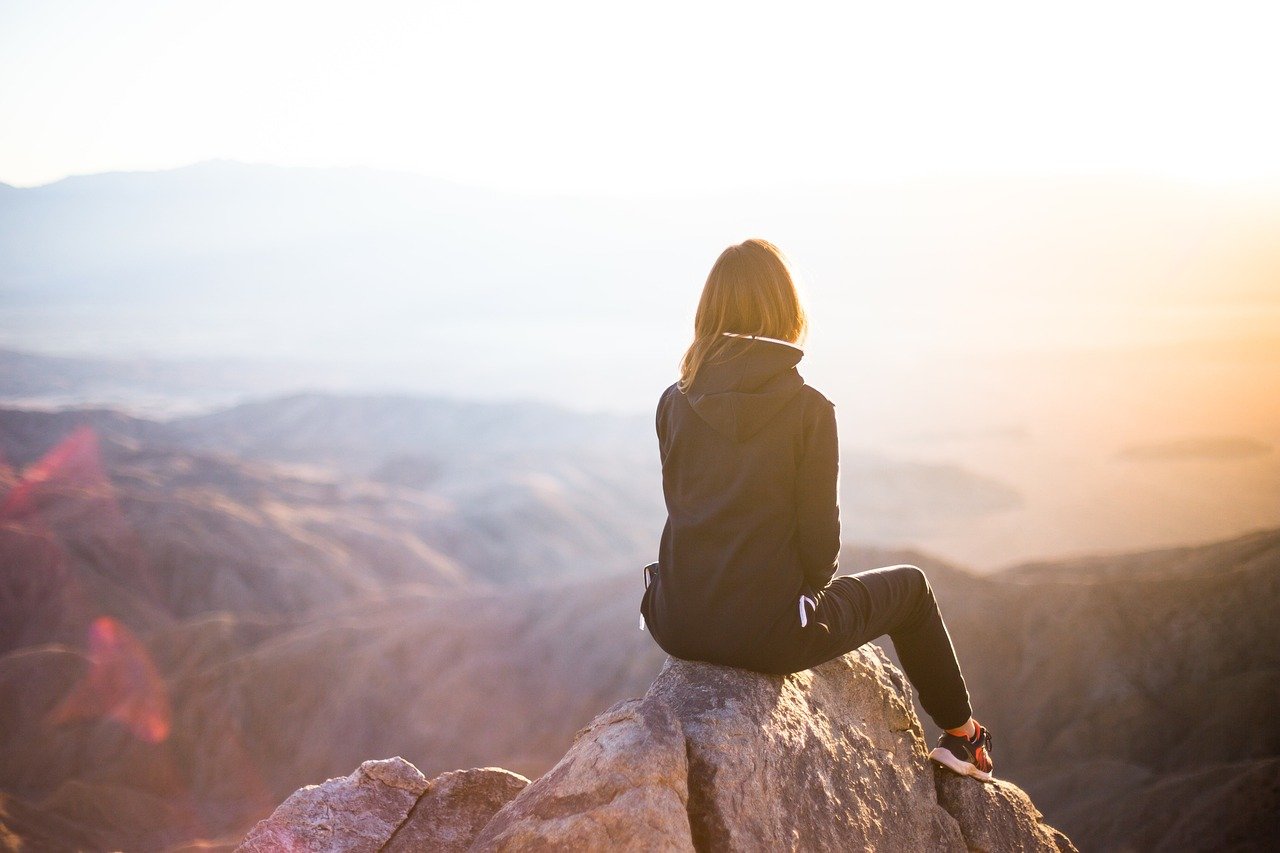 people, woman, travel, adventure, nature, trek, mountain, rock, sunset, cliff, black, hoodie, jacket, alone, thinking, freedom
